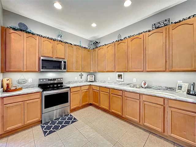 kitchen featuring appliances with stainless steel finishes and light tile patterned flooring