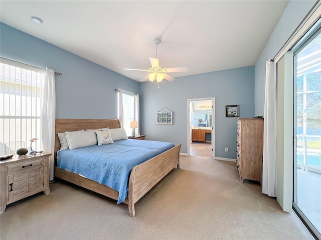 carpeted bedroom featuring access to exterior, ceiling fan, ensuite bath, and multiple windows