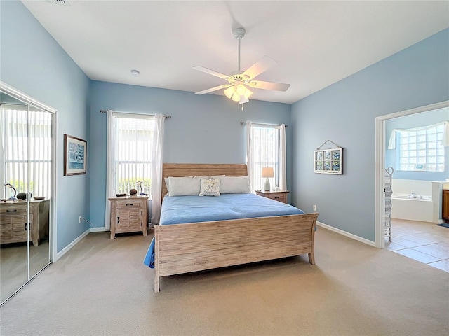 carpeted bedroom with connected bathroom and ceiling fan