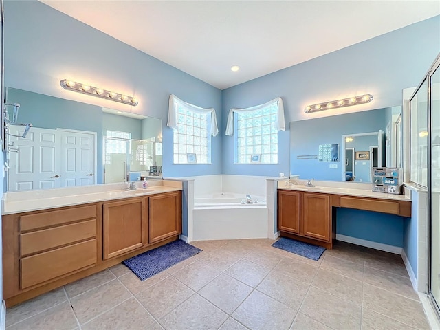 bathroom featuring shower with separate bathtub, vanity, and tile patterned floors