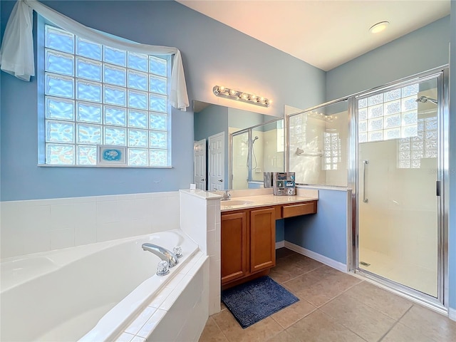 bathroom featuring tile patterned flooring, vanity, a healthy amount of sunlight, and shower with separate bathtub