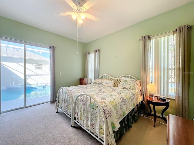 bedroom with access to outside, ceiling fan, and carpet