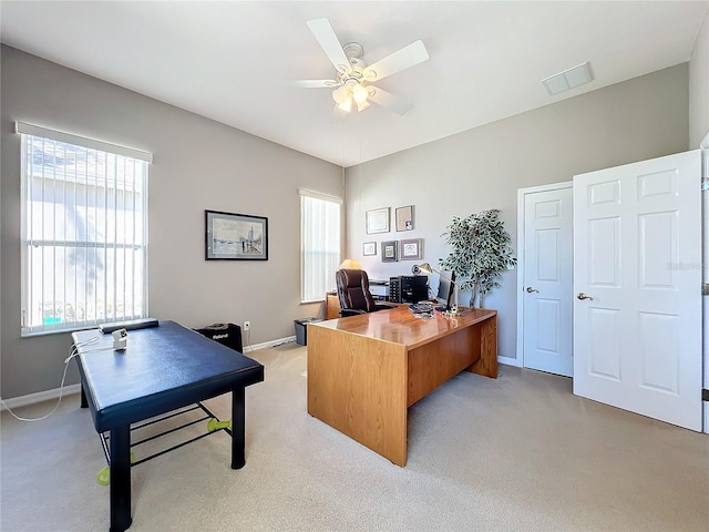 carpeted home office with ceiling fan