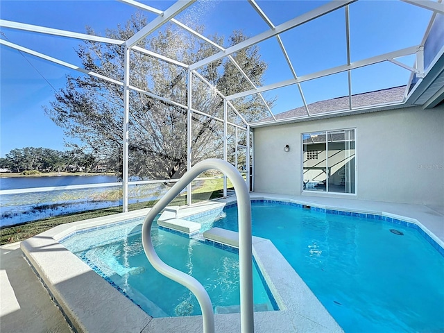 view of pool with glass enclosure and a water view