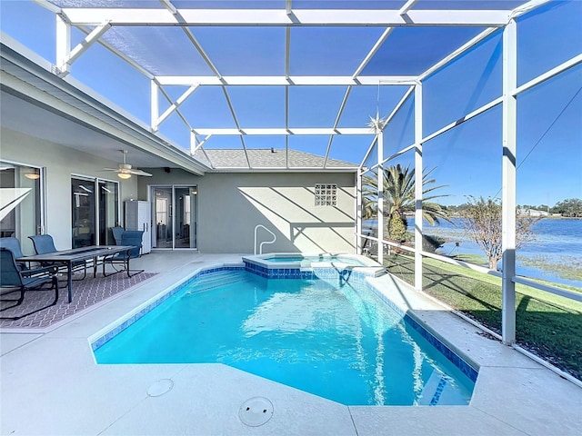 view of pool featuring ceiling fan, a lanai, an in ground hot tub, and a water view