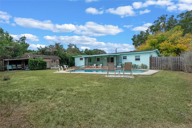 rear view of property with a lawn and a patio area