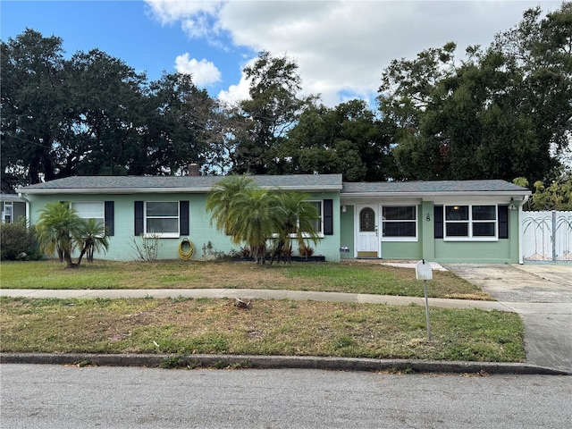 ranch-style home with a front lawn