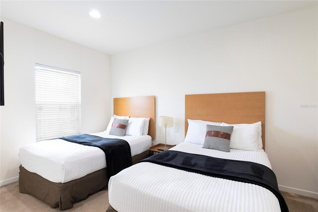 bedroom featuring light colored carpet