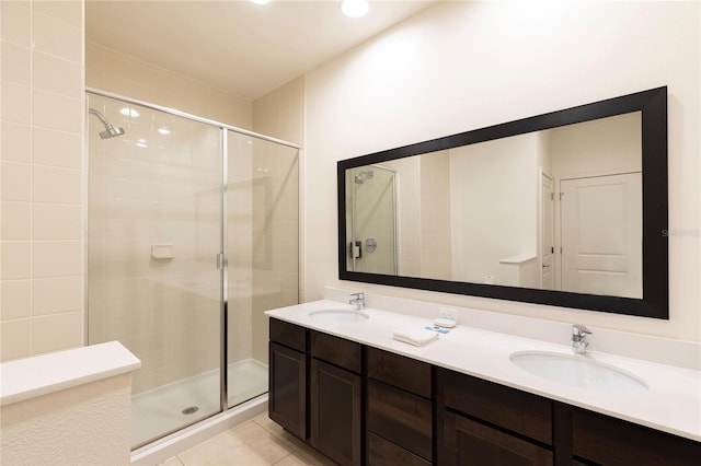 bathroom featuring tile patterned flooring, vanity, and an enclosed shower