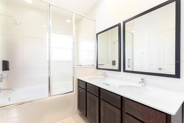 bathroom featuring vanity and shower / bath combination with glass door