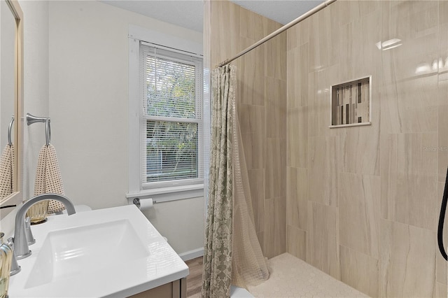 bathroom featuring vanity and curtained shower