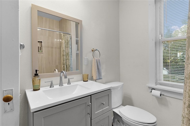 bathroom with vanity, a shower with curtain, and toilet