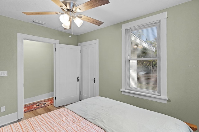 bedroom featuring light hardwood / wood-style flooring and ceiling fan