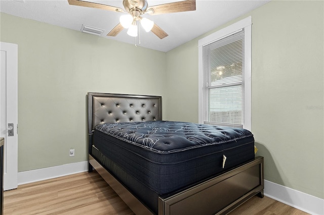 bedroom with hardwood / wood-style flooring and ceiling fan