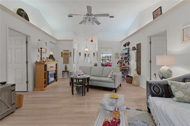 living room with light hardwood / wood-style floors, vaulted ceiling, and ceiling fan