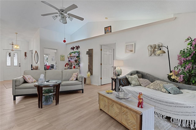 living room featuring ceiling fan, high vaulted ceiling, and light wood-type flooring