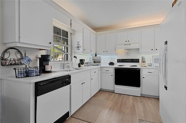 kitchen featuring white cabinets, light wood-type flooring, white appliances, and sink