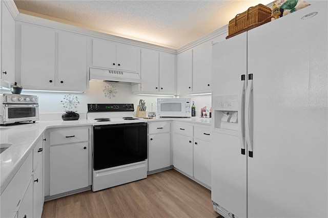 kitchen featuring white cabinets, light wood-type flooring, white appliances, and a textured ceiling