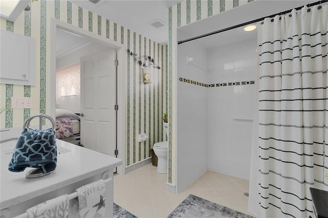 bathroom featuring tile patterned flooring, a shower with curtain, toilet, and vanity