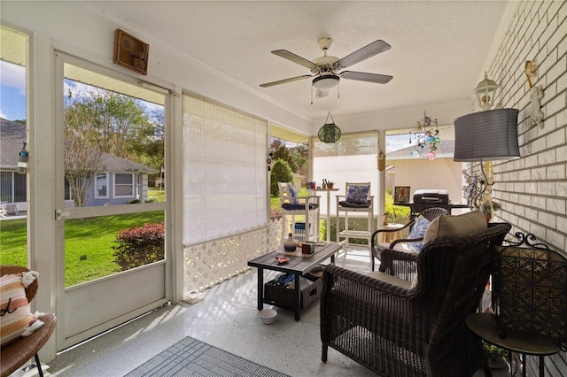 sunroom featuring ceiling fan and a healthy amount of sunlight