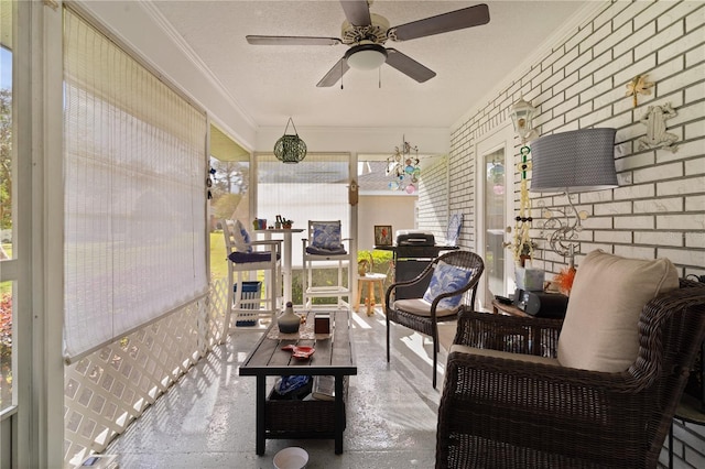 sunroom / solarium featuring ceiling fan and plenty of natural light