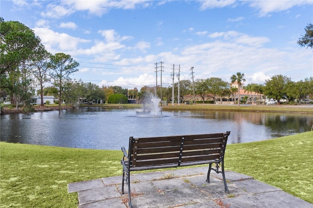 view of home's community featuring a water view and a yard