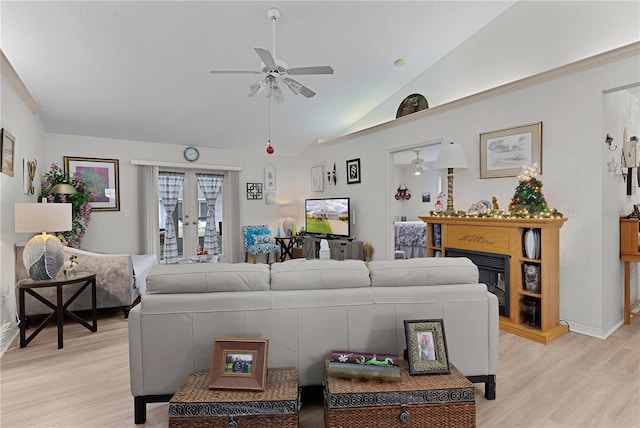 living room with ceiling fan, french doors, lofted ceiling, and light wood-type flooring