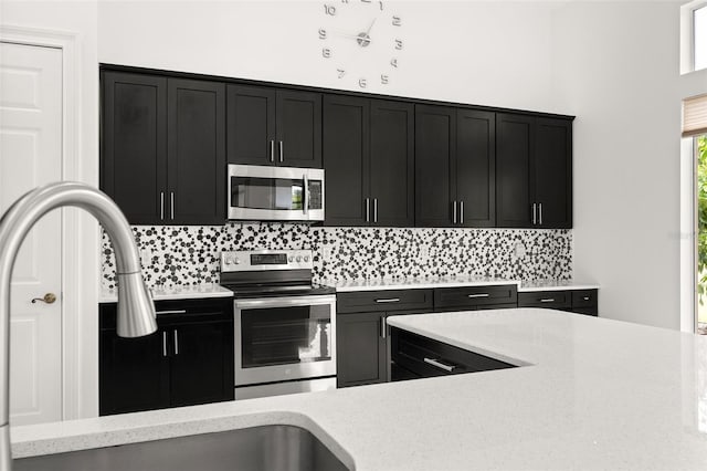 kitchen featuring sink, appliances with stainless steel finishes, and tasteful backsplash