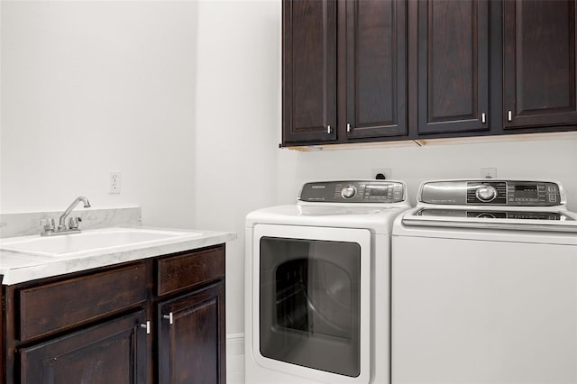 laundry room featuring cabinets, washing machine and dryer, and sink