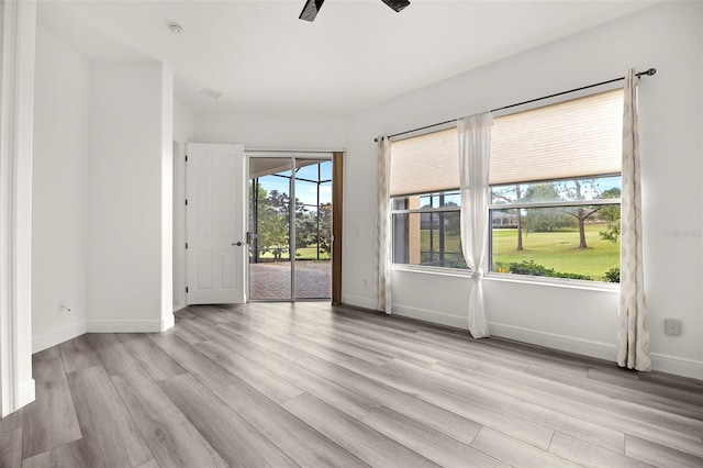 empty room with ceiling fan and light wood-type flooring