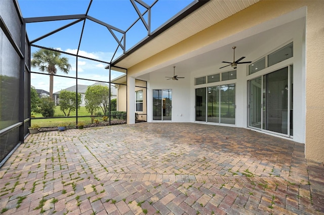 unfurnished sunroom featuring ceiling fan