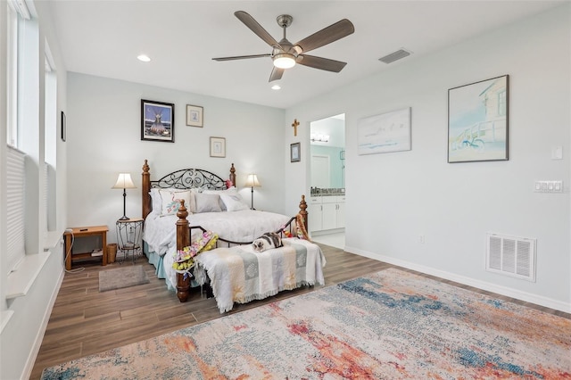 bedroom with ensuite bath, ceiling fan, and multiple windows