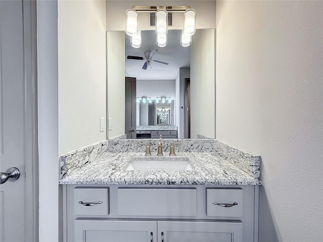 bathroom featuring ceiling fan and vanity