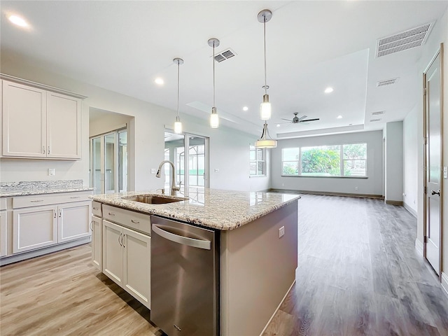 kitchen featuring dishwasher, ceiling fan, white cabinetry, and sink