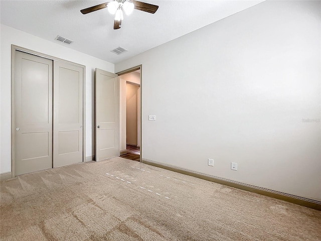 unfurnished bedroom featuring ceiling fan, a closet, and carpet floors