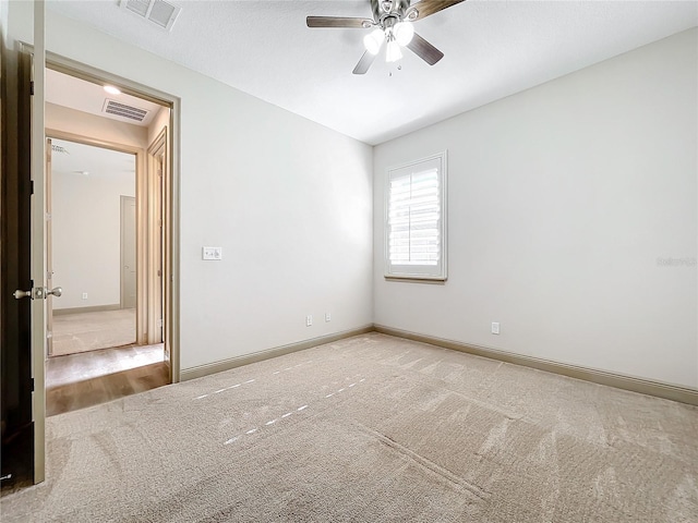 unfurnished room with carpet floors and ceiling fan