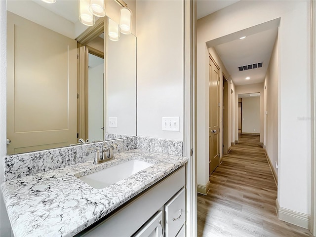 bathroom with hardwood / wood-style floors and vanity