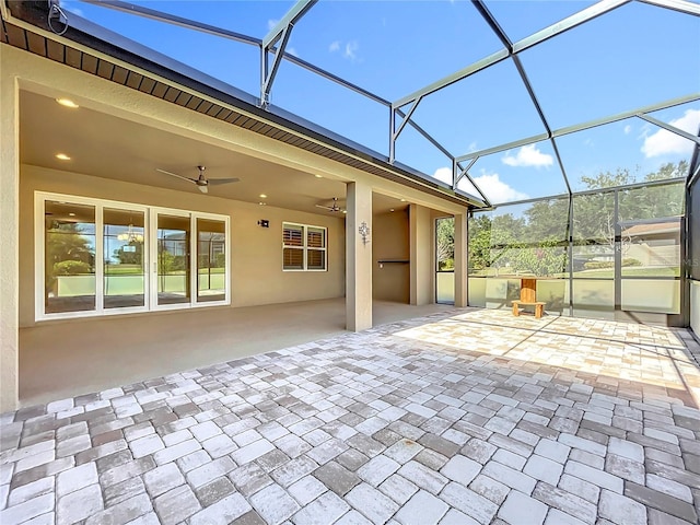 view of patio featuring glass enclosure and ceiling fan