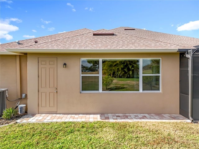 doorway to property featuring a yard