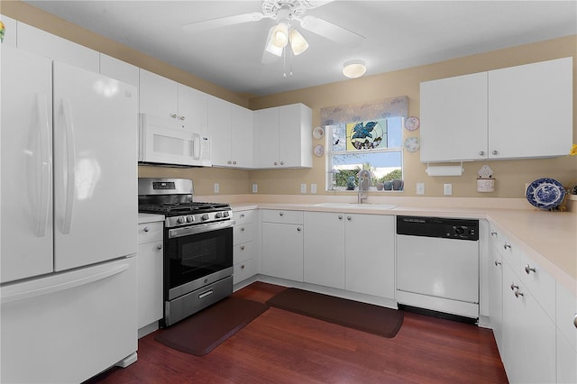 kitchen with white cabinetry, sink, dark hardwood / wood-style floors, and white appliances