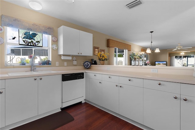 kitchen with kitchen peninsula, dark wood-type flooring, sink, dishwasher, and white cabinetry