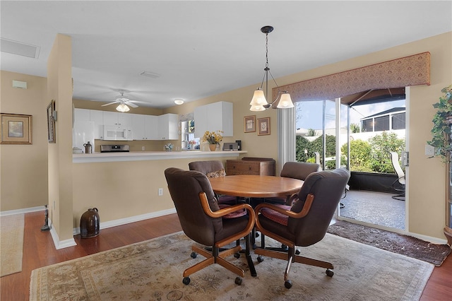 dining room featuring dark hardwood / wood-style floors and ceiling fan