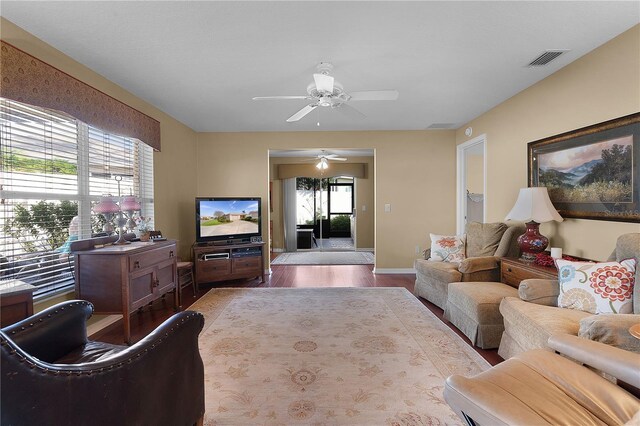 living room featuring hardwood / wood-style floors, ceiling fan, and a healthy amount of sunlight