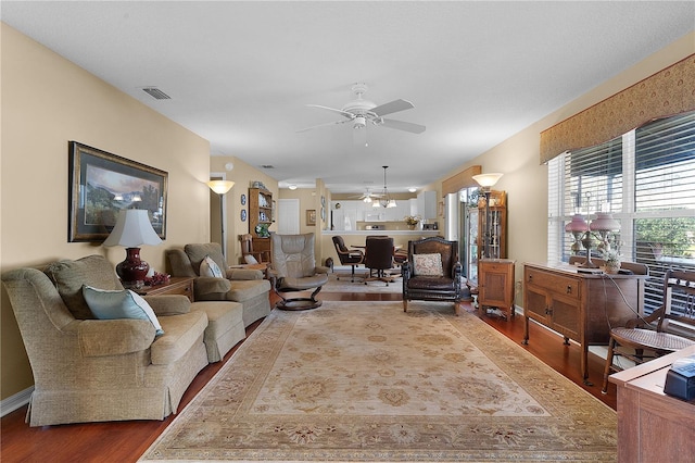 living room with wood-type flooring and ceiling fan