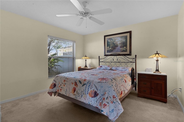 bedroom with ceiling fan and light carpet