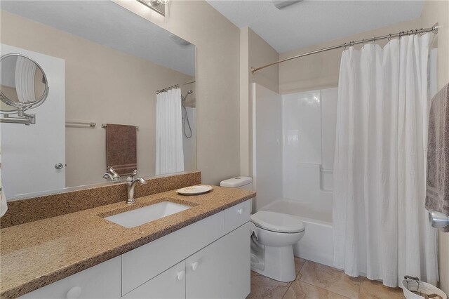 full bathroom featuring tile patterned floors, vanity, shower / bath combination with curtain, and toilet