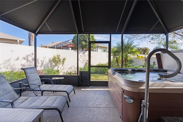 sunroom with a jacuzzi