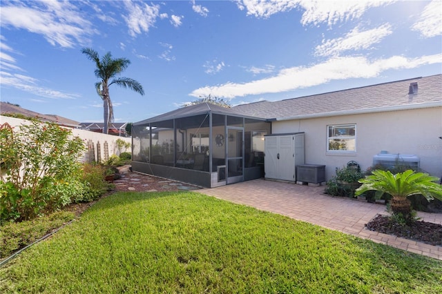 back of property with a lawn and a patio