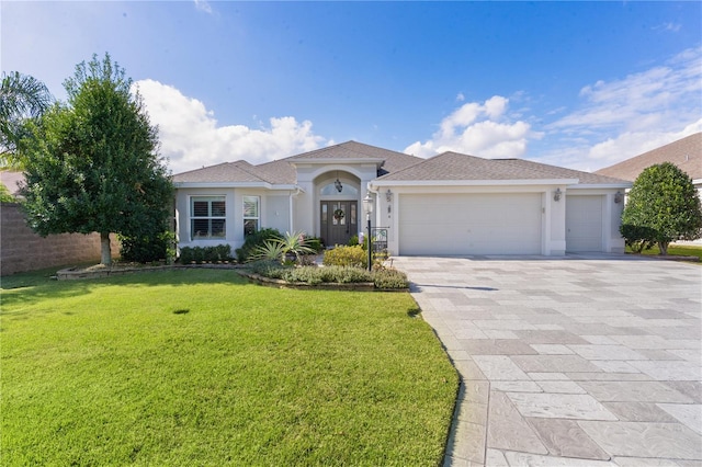 view of front of property featuring a front yard and a garage