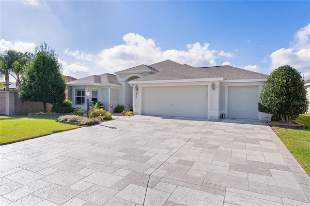 view of front of house featuring a garage and a front lawn